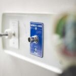 Zbliżenie szpitalnego gniazda tlenowego i podłączonego sprzętu